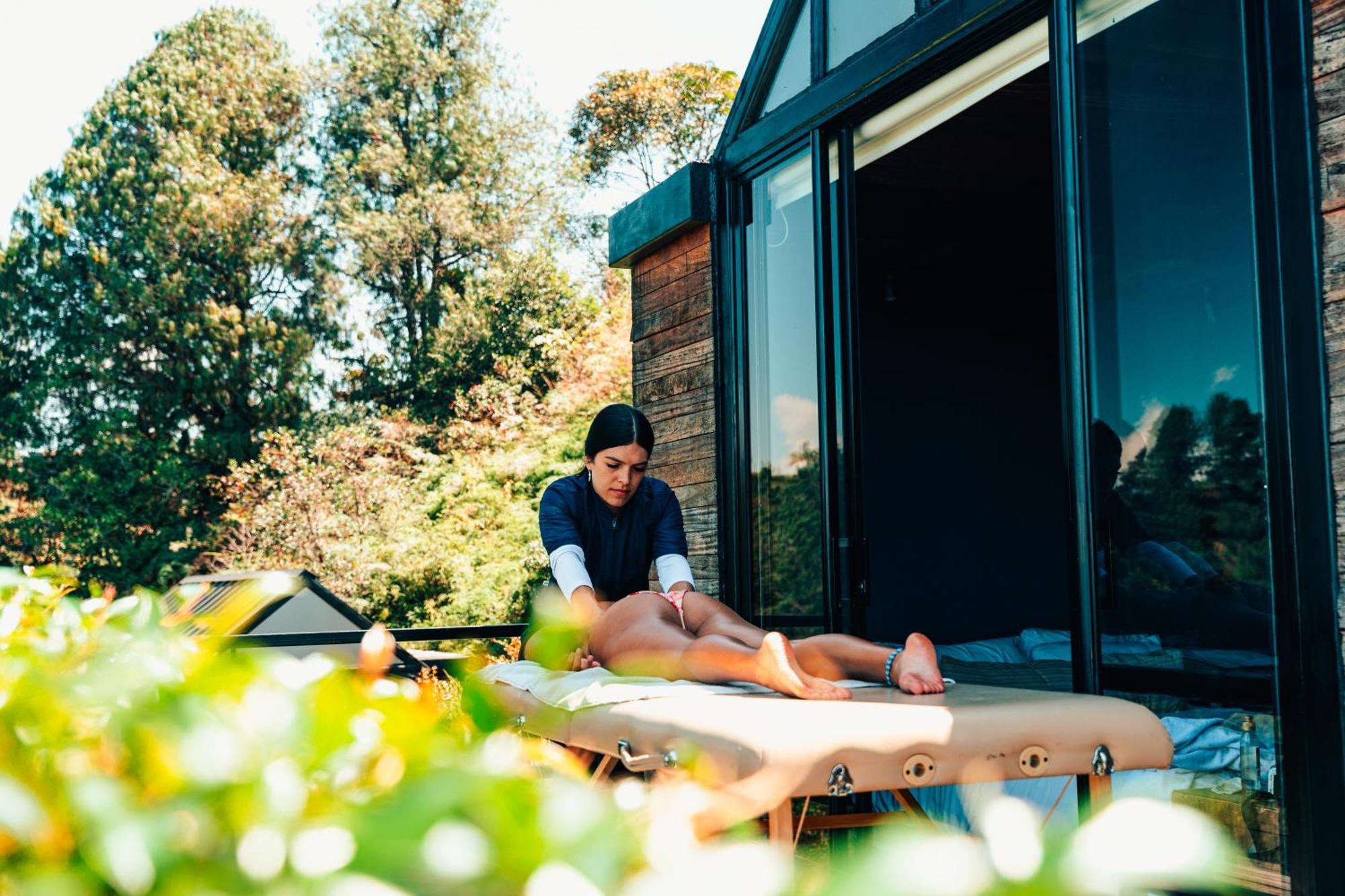 The Boato Hotel Guatapé Exteriör bild A massage therapist treating a client
